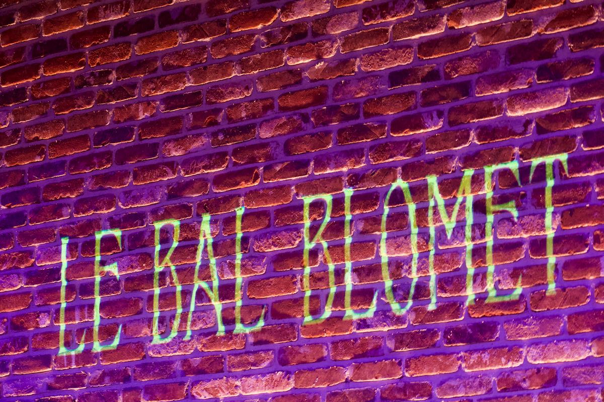 Il est écrit sur le mur de l'arrière scène Le Bal Blomet avec un projecteur vidéo